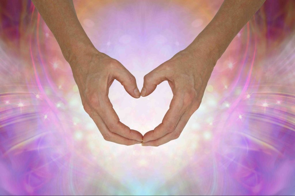 Sending you pure unconditional love - hands making a gentle hear